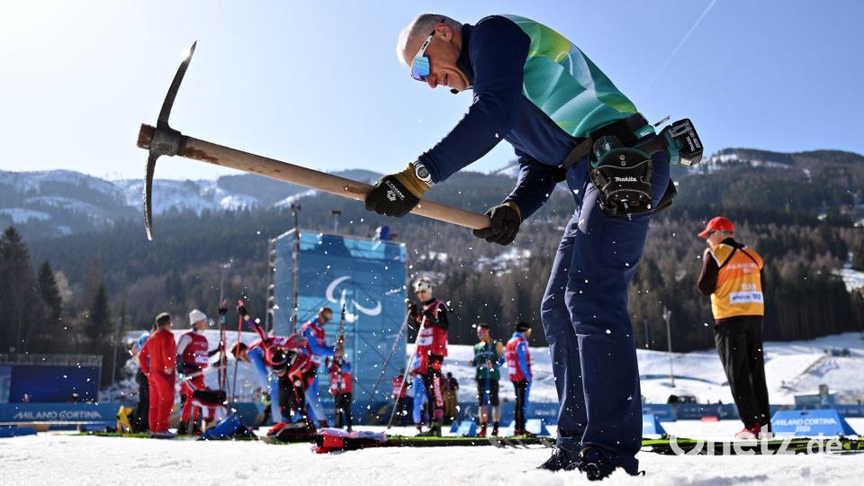 Ein Helfer präpariert die Strecke in Tesero. Bild: Martin Schutt/dpa