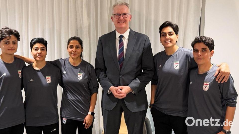 Australiens Innenminister Tony Burke (M) mit Spielerinnen des Irans. Bild: -/Australia Ministry of Home Affairs via AP/dpa
