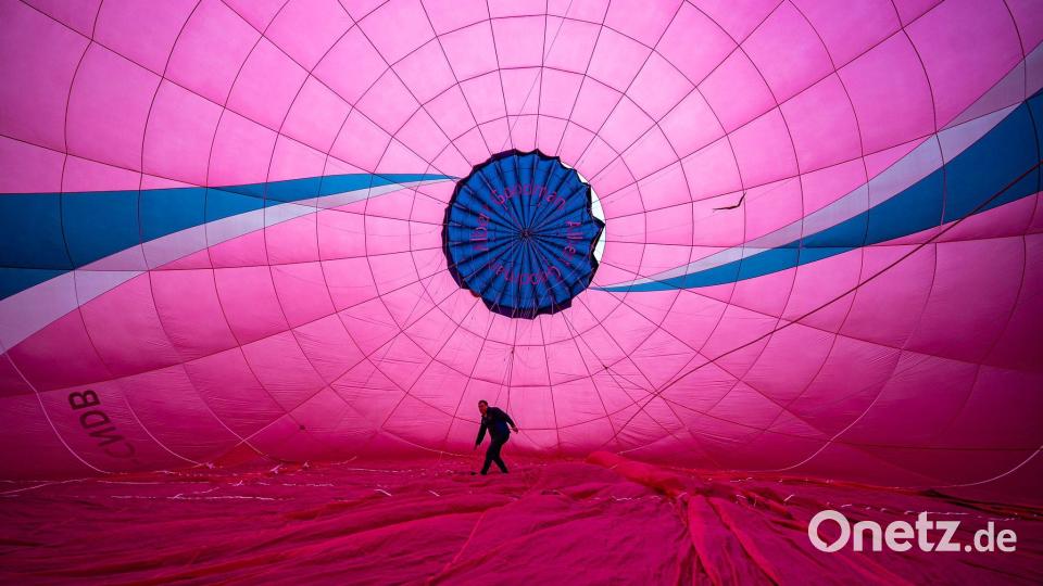 Ein Heißluftballonpilot prüft die Innenverankerung der Ballonhülle. Die jährliche Bristol Balloon Fiesta ist für den 7. bis 9. August geplant. Bild: Ben Birchall/PA Wire/dpa