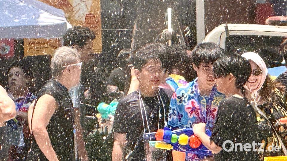 Einheimische und Touristen feiern traditionell zusammen - die meisten sind nach wenigen Minuten klatschnass. Bild: Carola Frentzen/dpa