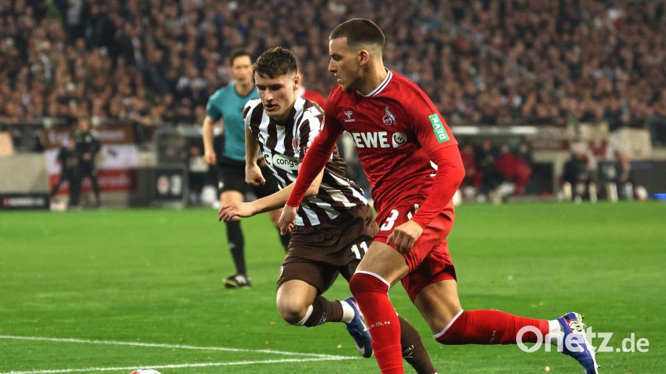 St. Paulis Arkadiusz Pyrka (l) und Kölns Said El Mala kämpfen um den Ball. Bild: Christian Charisius/dpa