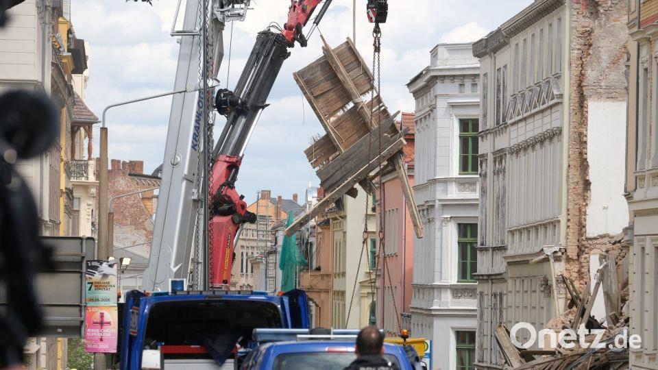 An der Unglücksstelle werden Trümmerteile mit einem Kran bewegt. Bild: Sebastian Willnow/dpa