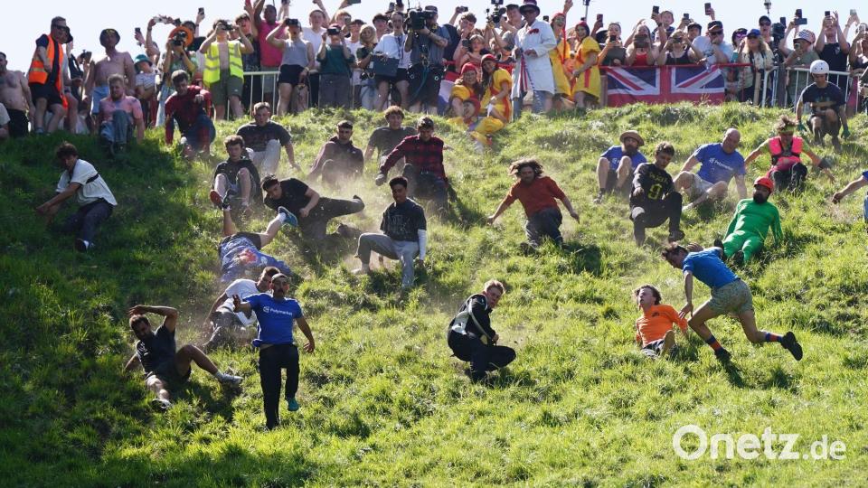 Das Käserennen in England hat Tradition. Bild: Jacob King/PA Wire/dpa