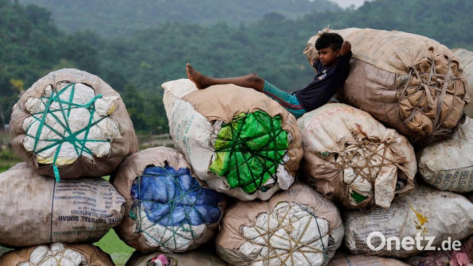 Weltumwelttag: Junger Lumpensammler pausiert auf Mülldeponie Bild: Anupam Nath/AP/dpa