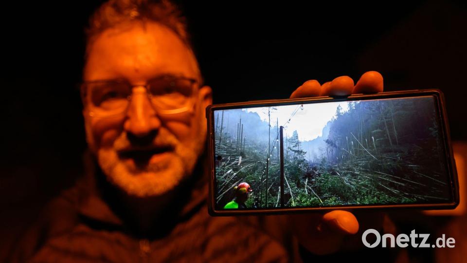 Roman Rolof, Bürgermeister von Rathen, zeigt nach schweren Unwettern ein Foto von Schäden auf seinem Smartphone, das er selbst aufgenommen hat. Bild: Robert Michael/dpa