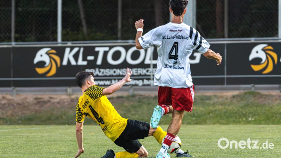 Der SC Luhe-Wildenau setzt sich im Duell gegen den FC Amberg mit 3:1 durch. Fabian Geitner (in Gelb) klärt per präziser Grätsche gegen Caner Gümüsbas (in Weiß). Bild: Hannah Dirscherl