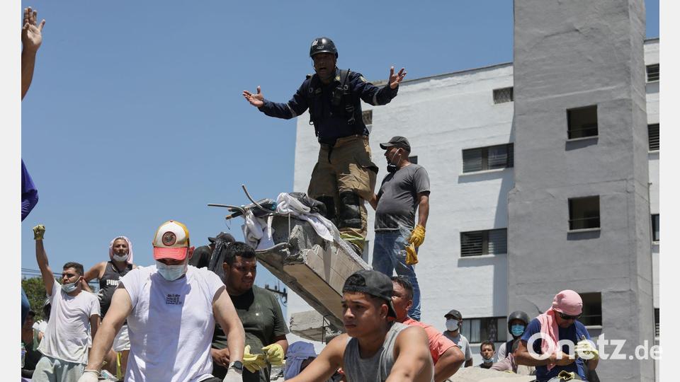 Eine Rettungskraft bittet um Ruhe während der Suche nach Überlebenden nach einem Erdbeben in der Stadt Cali in Kolumbien. Bild: Santiago Saldarriaga/AP/dpa
