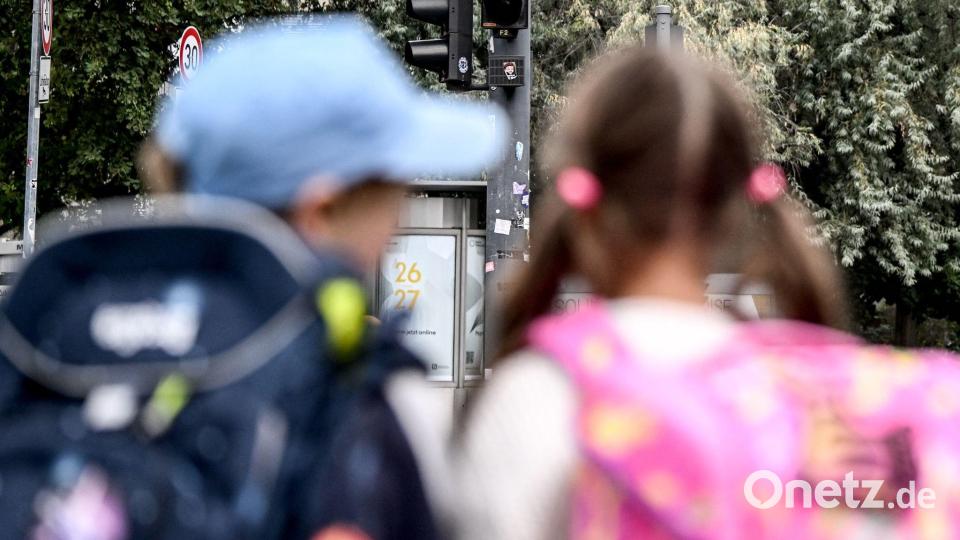 Die Schulanfänger Edgar (6) und Angelina (5) stehen an einer Straße am Rande der Schulanfangskampagne „Achtung Schulweg! Sicher starten, sicher ankommen“ in Berlin. Bild: Britta Pedersen/dpa