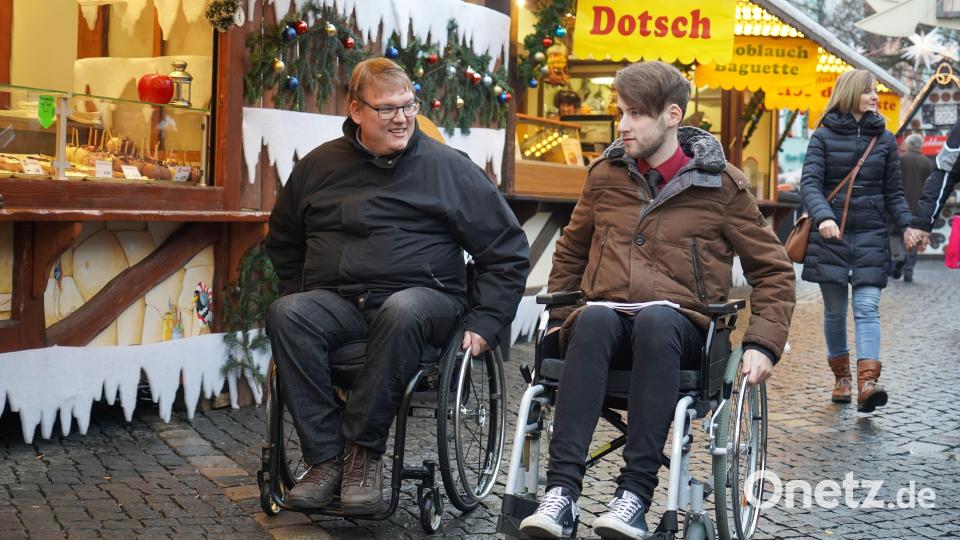 Häufig sind die wirklich hilfreichen Dinge für Rollstuhlfahrer die, die unbewusst so gemacht werden. Die Höhe der Preisschilder in den Buden zum Beispiel. Alexander Grundler (links) erklärt mir, worauf es ankommt, damit alle voll an der Gesellschaft teilhaben können. Bild: gld