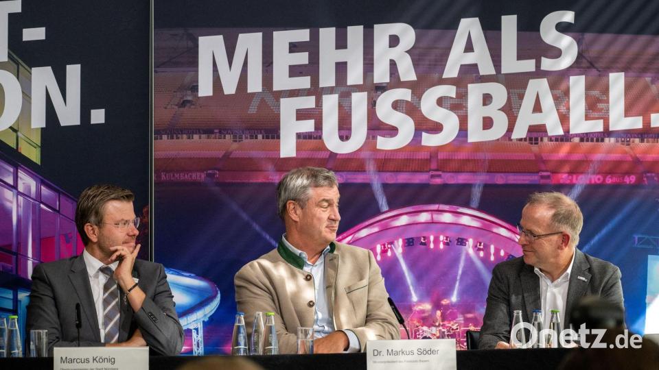 Ministerspräsident Söder (Mitte) kündigt die Übernahme der Hälfte der Kosten durch den Freistaat an. Bild: Pia Bayer/dpa