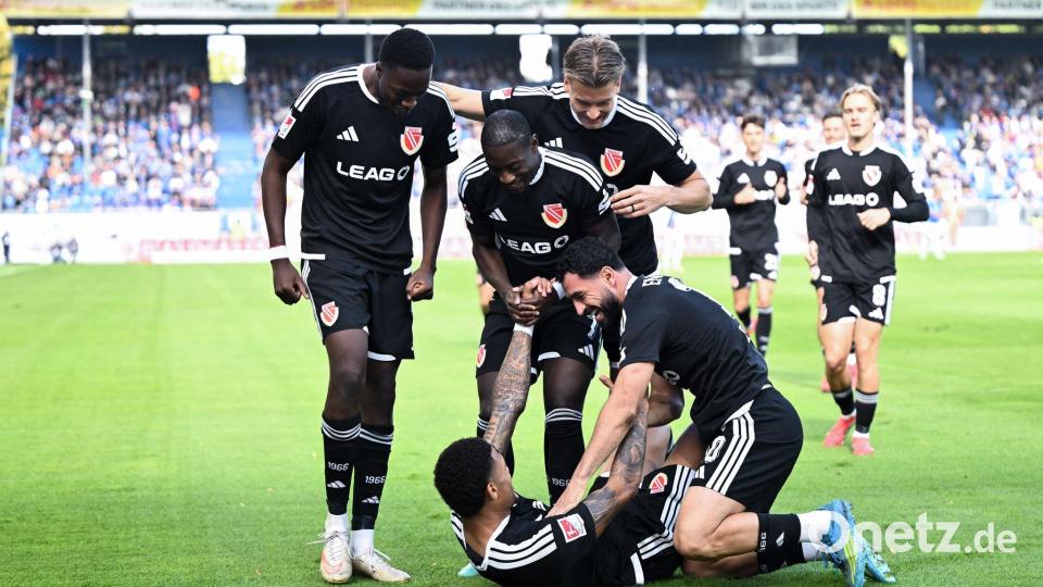 Die Cottbuser bejubeln den 1:0-Führungstreffer durch Justin Butler (am Boden). Bild: Florian Wiegand/dpa