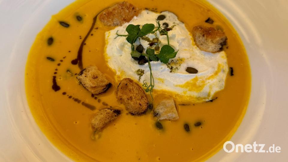 Kürbissuppe mit geröstetem Hokkaido macht sich gut im Teller mit einem Klecks Sahne, Kürbiskernen und angeröstetem Brot. Bild: Ilse Hauer