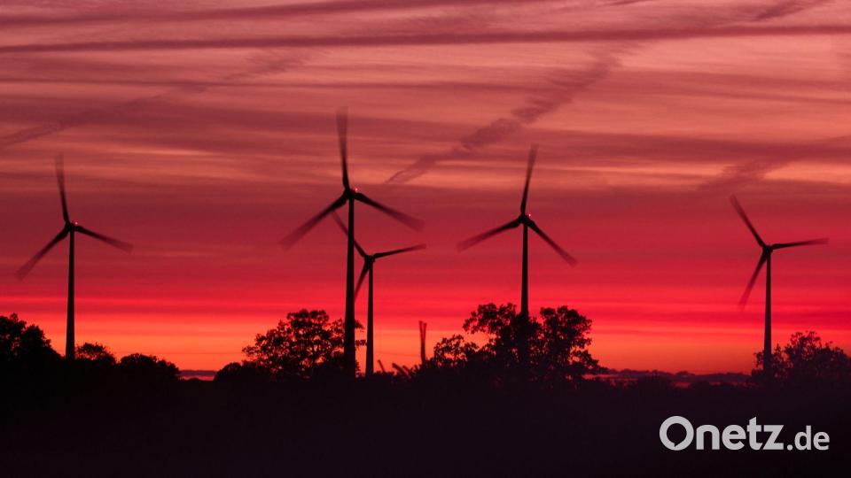 Die Rotoren von Windkraftanlagen drehen sich kurz nach Sonnenuntergang in einem Windpark in Mecklenburg-Vorpommern. Bild: Jens Büttner/dpa