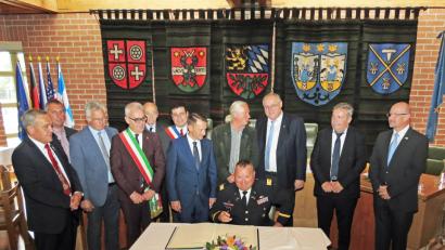 Bild: rdo, Autor [RDO] (REINHOLD.DOBMEIER@T-ONLINE.DE)
Leutnant Colonel Gregory Scrivens als Kommandeur der Garrison Bavaria und Zdeněk Král (stehend dahinter) sowie alle Ober- und Bürgermeister der Partnerstädte tragen sich als Zeugen des Festaktes zum Partnerschaftsjubiläum in das Goldene Buch der Stadt Weiden ein. Bild: Dobmeier