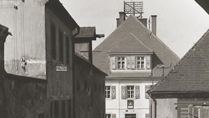 Bild: exb
Das Polizeigebäude im Jahr 1918 zwischen dem hinteren Rathausbogen und dem alten Schulgebäude, heute Stadtkämmerei.