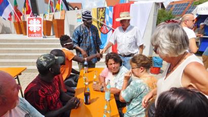 Bild: hai
Pfarrvikar Augustine Oburota (stehend links) im Gespräch mit senegalischen Trommlern und Speichersdorfer Bürger. Wie er nutzen diesmal aber weniger Besucher die Möglichkeit, mit Menschen anderer Kulturen ins Gespräch zu kommen.