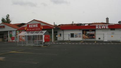 Bild: wro
Die Brandspuren am Dach sind noch sichtbar. Der Rewe-Markt soll wieder an seinem alten Standort neu aufgebaut werden. Für die Übergangszeit wird noch nach einer Lösung gesucht.