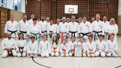 Bild: dob
Die Karatekas präsentieren stolz das Qualitätszertifikat, das der Präsident des Deutschen Karate Verbands (DKV) Wolfgang Weigert (mittlere Reihe, Dritter von rechts) den Vohenstraußer Sportlern verleiht. Dojo-Leiter Marcel Bieber (mittlere Reihe, Vierter von rechts) nimmt die Auszeichnung entgegen.