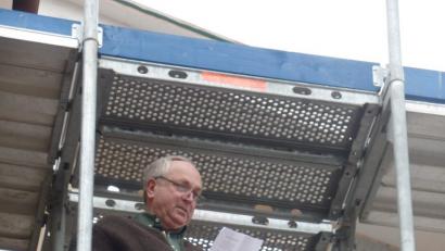 Bild: Brendel, Hubert (BR)
Holzingenieur Konrad Zimmermann vom gleichnamigen Zimmereibetrieb trägt den Richtspruch vor. Zum Gelingen der Maßnahme hebt er drei Mal das Glas und lässt es dann zerspringen.