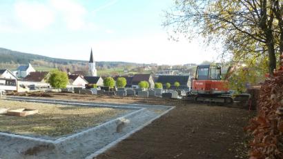 Bild: Portner
Im Friedhof Schönsee entsteht ein Urnenfeld mit bodengleichen Platten (Mitte). Außerhalb des Gehweges, der den Platz in U-Form erschließen wird, ebnet der Bauhof derzeit das Gelände für Urnenstätten mit traditionellen Grabsteinen.