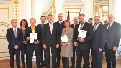 Bild: gib
Ausgezeichnet werden (vorne, mit Urkunde, von links) Franz Floth, Margit Kirzinger und Josef Beimler. Regierungspräsident Axel Bartelt (vorne, Dritter von links) und kommunale Vertreter gratulieren.