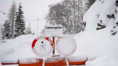 Bild: Lino Mirgeler/dpa
Ein Schild weist an einer Wegsperre am Spitzingsee auf eine Lawinengefahr hin.