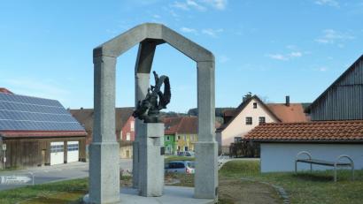 Bild: Portner
Das Knellinger-Denkmal an der Teunzer Straße/Abzweigung Wolfgrubenweg wurde im Jahr 1999 auf Initiative des Heimatkundlichen Arbeitskreises errichtet. Neben den Sitzbänken erfreuen im Sommer die Rosenbeete.