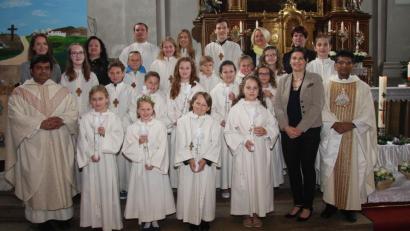 Bild: wro
Den Kommuniongottesdienst gestalteten Pfarrer Joseph (rechts) und Pater Martin (links) gemeinsam. Gekommen waren auch die Rektorin der Grundschule Wiesau, Inge Dick (vorne, Zweite von rechts), und die Lehrerin der dritten Klasse, Julia Greger (hinten links). Es gratulierten auch die Ministranten und die Tischmütter.
