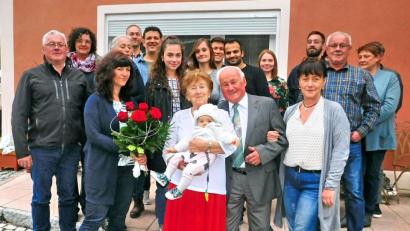 Bild: hai
Sechs rote Rosen gibt es für Mathilde Olischer (vorne Mitte) zur diamantenen Hochzeit. Das größte Geschenk für sie und ihren Mann Josef (rechts daneben) ist aber Urenkeltochter Emilia.