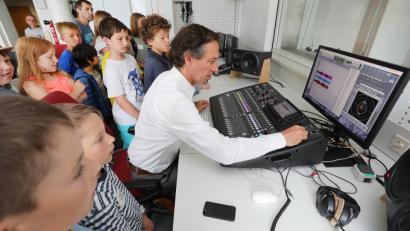 Bild: Wolfgang Steinbacher
Professor Maximilian Kock zeigte den Teilnehmern der Kinder-Uni, wie die verschiedenen Instrumente einer Band aufgenommen werden.