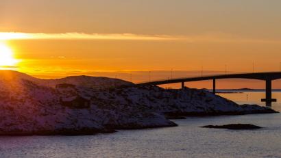 Bild: Hinrich Bäsemann
Die Sonne geht hinter der Sommaroy-Brücke unter, die die Inseln Kvaloya und Sommaroy verbindet.