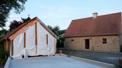 Bild: do
Die Bodenplatte für die künftige Münchsreuther Gemeinschaftshalle neben dem historischen Hirthaus ist mit kräftiger Unterstützung der Dorfbewohner schon betoniert. In den nächsten Wochen folgt der Wandaufbau in Holzständer-Bauweise.