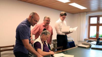 Bild: Peter Bogner
Interkommunaler Archivar David Austermann (rechts), Bürgermeister Josef Reindl (Zweiter von rechts) und Verwaltungsobersekretär Sascha Fritzsche (links) freuen sich über die ehrenamtliche Mitarbeit von Elisabeth Frauendorfer.