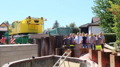 Bild: Stefanie Gradl
Bevor die Spundwand mit dem großen Spezialkran wieder herausgezogen wurde, trafen sich die Vertreter der Baufirmen zusammen mit Bürgermeister Hans-Martin Schertl (Mitte) und Bauamtsleiter Stefan Ertl (rechts) mit den Mitarbeitern des Klärwerks zu einer Baubesprechung von dem neuen Pumpwerk.