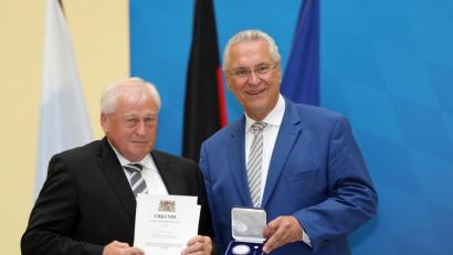 Bild: exb
Innenminister Joachim Herrmann (rechts) überreicht Bürgermeister Johann Wilhelm (links) die kommunale Verdienstmedaille.