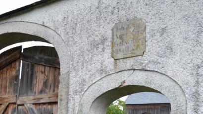 Bild: ui
Christl Brandl und Rüdiger Prölß mit Ziege "Seppl" unter der Tafel, aus dem Jahr 1868 auf dem Gollwitzerhof.