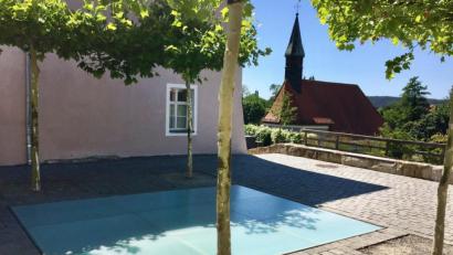 Bild: Götz
Der Tanzboden beim Pfleghof erinnert an den Komponisten Konrad Max Kunz, der nicht nur die Bayernhymne, sondern auch Zwiefache komponiert oder per Notenblatt für die Nachwelt aufgeschrieben hat. Die leuchtende Glasplatten wurden im Frühjahr durch Kinder zerstört.