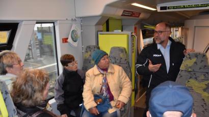 Bild: jak
Josef Prill, Präventionsbeauftragter im Bundespolizeirevier Weiden (rechts), gibt den Sensiwen-Teilnehmern in einem Regionalzug Sicherheitstipps für Bus und Bahn.