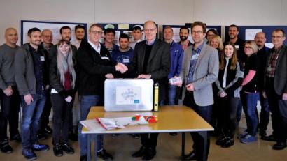 Bild: exb
Das Lean-Spiel aus Mitterteich nimmt Robert Köhler (BHS) von Standortleiter Stefan Rosner (vorne, von links) entgegen. Die Vertreter vieler namhafter Firmen der Region sind dabei.