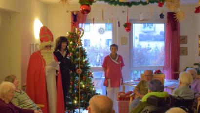 Bild: gpa
In jedem der drei Bereiche des BRK-Seniorenheims spricht der Nikolaus mit den Bewohnern, trägt ihnen ein Gericht vor und verteilt süße Kleinigkeiten. Ines Zeitzer von der Verwaltung darf den Bischofstab halten.