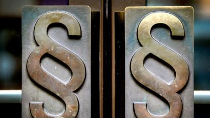 Bild: Oliver Berg
Paragrafen-Symbole sind an Türgriffen angebracht. Foto: Oliver Berg/dpa/Archivbild