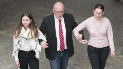 Bild: exb
Zwei Schülerinnen geleiten Schulleiter Anton Hochberger zum Geburtstagsständchen