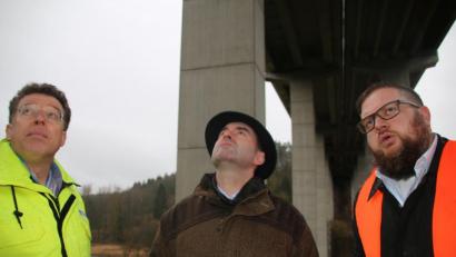 Bild: jrh
Der bayerische Wirtschaftsminister Hubert Aiwanger (Mitte) und die Tennet-Experten Paul Garmer (links) und René Queren suchen vergeblich nach Lösungen, die Erdkabel an der Waldnaabtalbrücke anzubringen.
