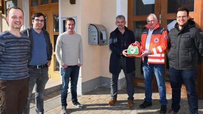 Bild: gf
BRK-Rettungsdienstleiter Erwin Gräml (Zweiter von rechts) übergab am Montag zwei Defibrillatoren an Bürgermeister Roger Hoffmann (Dritter von rechts). Die Geräte hängen künftig am Feuerwehrhaus in Traßlberg und an der Bushaltestelle in Altmannshof. Weiter auf dem Bild (von links) JU-Vorsitzender Markus Weiß, Manfred Hofmann und Benedikt Grünbauer sowie (rechts) CSU-Gemeinderat Johannes Hauer.