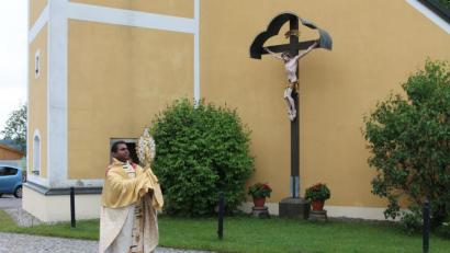 Bild: pi
Pfarrer Julius Johnrose segnet vor der Pfarrkirche Neukirchen zu St. Christoph den Ort in alle Himmelsrichtungen.