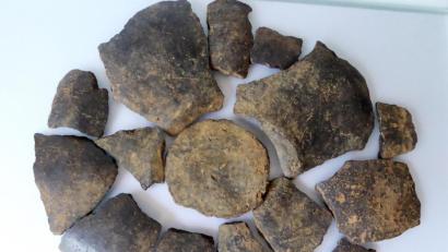 Bild: Kurt Engelhardt/exb
Für das Foto von der Urne wurde das Bodenstück und die aufgefundenen Teile der sich anschließenden Gefäßwandung zusammengelegt. Man sieht das Gefäß damit praktisch von unten.