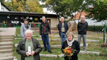 Bild: gz
Pfarrer Erwin Bauer gratuliert im Beisein von (hinten v.l.) stellvertretenden Kirchenpflegerin Nicola Hummer, Kirchenpfleger Klaus Härtl, Pfründebeirat Anton Hochwart und Rechnungsführer Karl Schmid der Kindergartenleiterin Ramona Zangl zum 25. Jubiläum.