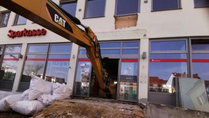 Bild: Portner
Die Bagger knabbert sich schon ins Innere vor. Bald wird von der Sparkasse Oberviechtach nichts mehr zu sehen sein.