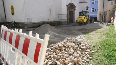 Bild: Gabi Schönberger
Der Kieselstein-Belag vor dem Haupteingang der Michaelskirche ist beiseite geräumt. Bagger der Baufirma Schieder aus Bechtsrieth graben sich in den Untergrund. Zunächst werden die Entwässerungsleitungen erneuert.