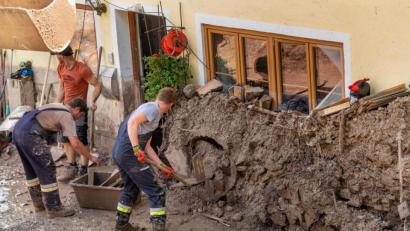 Bild: Peter Kneffel
Schönau Am Königssee: Anwohner graben ein Haus am Waldrand aus, das von Schlamm- und Geröllmassen bis zu drei Meter hoch eingeschlossen ist. Der Freistaat will den Betroffenen zügig mit Geld helfen.